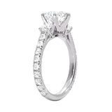 Diamond ring with a central gemstone and smaller stones on a white background