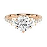 Rose gold multi stone engagement ring with round side stones and pavé accents