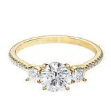 Gold ring with a central diamond and smaller diamonds on a white background