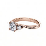 Rose gold ring with heart-shaped diamond on a white background