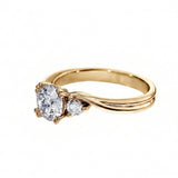 Gold ring with a heart-shaped diamond on a white background