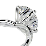 Detailed side view of an infinity twist ring showing the intertwined shank and professional four-prong setting.