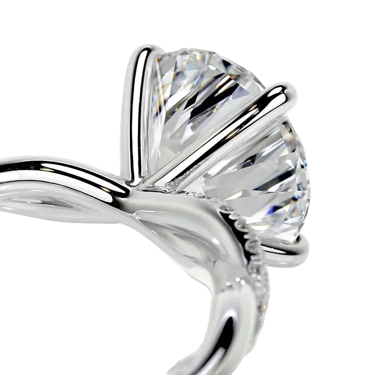 Detailed side view of an infinity twist ring showing the intertwined shank and professional four-prong setting.