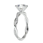 Close-up of a high-quality D-color VVS1 round brilliant moissanite center stone on a shimmering pavé twisted shank.