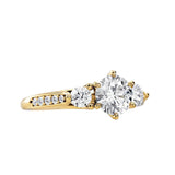 Gold ring with a large diamond and smaller diamonds on a white background