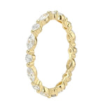 Top-down view of a D-color VVS1 alternating marquise and round stone full eternity wedding band in yellow gold.