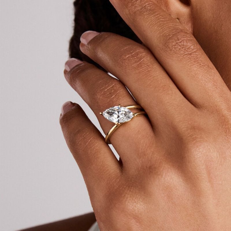 Dream proposal surprise showing a woman admiring her high-quality GRI certified moissanite ring from ApolloGem jewelry studio.