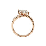 Top-down view of a D-color VVS1 marquise brilliant moissanite in a yellow gold solitaire setting.