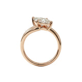 Top-down view of a D-color VVS1 marquise brilliant moissanite in a yellow gold solitaire setting.