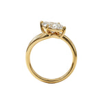 Top-down view of a D-color VVS1 marquise brilliant moissanite in a yellow gold solitaire setting.