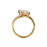 Top-down view of a D-color VVS1 marquise brilliant moissanite in a yellow gold solitaire setting.