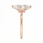 Symmetrical top-down view of a marquise moissanite solitaire in a polished rose gold setting.
