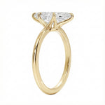 Detailed side view of the marquise solitaire showing the six-prong crown architecture and round band.