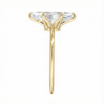 Symmetrical top-down view of a marquise moissanite solitaire in a polished yellow gold setting.