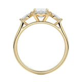 Top-down view of a symmetrical marquise-only three-stone ring on a polished yellow gold comfort-fit band.