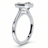 Milgrain detail on gold bezel setting step cut emerald stone close up