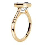 Emarald cut Moissanite engagement ring round shank with a bezel setting, on a gold band, against a white background.Moissanite engagement ring cape town south africa grand diamonds ralph jacobs jeulia lab grown diamond"