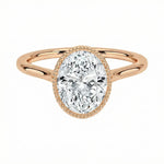 Rose gold ring with a pear-shaped diamond on a white background