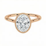 Rose gold ring with a pear-shaped diamond on a white background