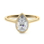 Pear shape Moissanite lab grown diamond engagement ring round shank with a bezel setting, on a gold band, against a white background.Moissanite engagement ring cape town south africa grand diamonds ralph jacobs jeulia 