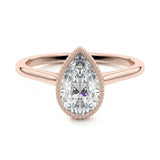 Milgrain detail on gold bezel setting teardrop stone VVS clarity close up