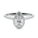 Pear shape Moissanite lab grown diamond engagement ring round shank with a bezel setting, on a gold band, against a white background.Moissanite engagement ring cape town south africa grand diamonds ralph jacobs jeulia 