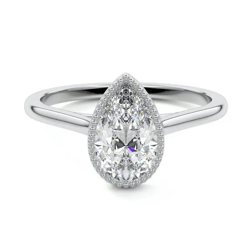 Pear shape Moissanite lab grown diamond engagement ring round shank with a bezel setting, on a gold band, against a white background.Moissanite engagement ring cape town south africa grand diamonds ralph jacobs jeulia 