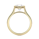 Round cut Moissanite lab grown diamond engagement ring round shank with a bezel setting, on a gold band, against a white background.Moissanite engagement ring cape town south africa grand diamonds ralph jacobs jeulia 