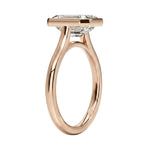 Top-down view of a D-color VVS1 emerald stone in a polished rose gold bezel setting