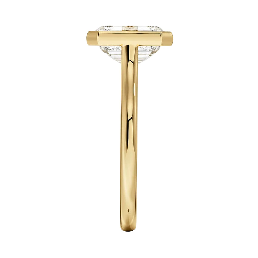 Side view of The Modern Emerald ring showing the raised bezel and round tube band