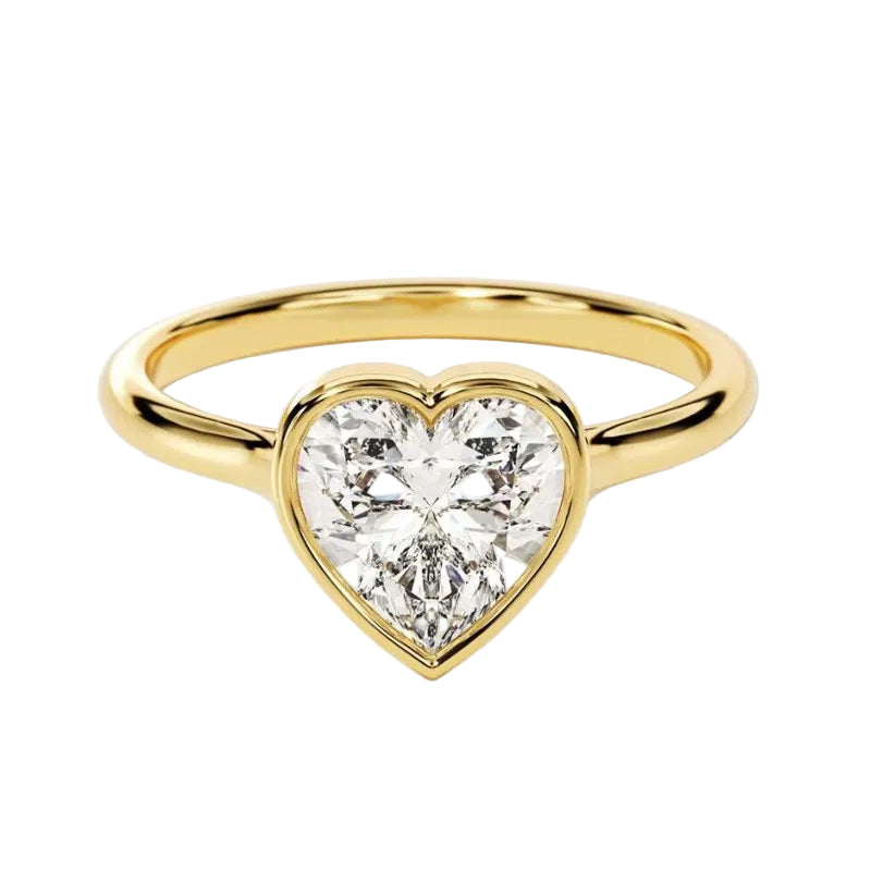  Heart shae Moissanite lab grown diamond engagement ring round shank with a bezel setting, on a gold band, against a white background.Moissanite engagement ring cape town south africa grand diamonds ralph jacobs jeulia 