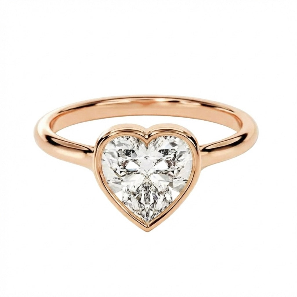 Rose gold ring with a heart-shaped diamond on a white background