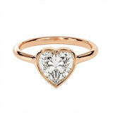 Rose gold ring with a heart-shaped diamond on a white background