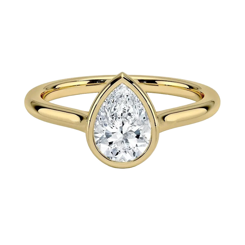 Pear shape Moissanite lab grown diamond engagement ring round shank with a bezel setting, on a gold band, against a white background.Moissanite engagement ring cape town south africa grand diamonds ralph jacobs jeulia 