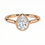 The Modern Pear cut moissanite ring with a smooth gold bezel ApolloGem