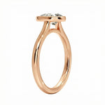 Top-down view of a D-color VVS1 pear stone in a polished gold bezel setting
