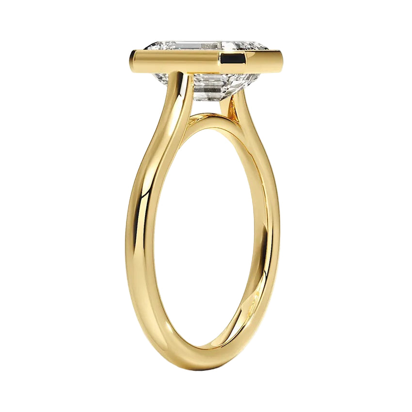 Princess cut Moissanite lab grown diamond engagement ring round shank with a bezel setting, on a gold band, against a white background.Moissanite engagement ring cape town south africa grand diamonds ralph jacobs jeulia 