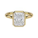 The Modern Radiant cut moissanite solitaire ring with a smooth yellow gold bezel ApolloGem