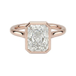 The Modern Radiant cut moissanite solitaire ring with a smooth rose gold bezel ApolloGem