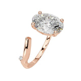 Close-up of a high-quality D-color VVS1 oval moissanite center stone on an artistic rose gold band.