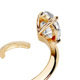 Detailed side view of an open-ended bypass ring showing the floating oval moissanite and professional prong setting.