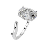 Close-up of a high-quality D-color VVS1 oval moissanite center stone on an artistic white gold band.