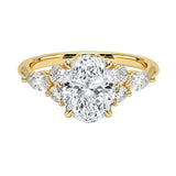 Luxury oval cut moissanite engagement ring in yellow gold featuring an organic cluster of round and marquise side stones ApolloGem South Africa.