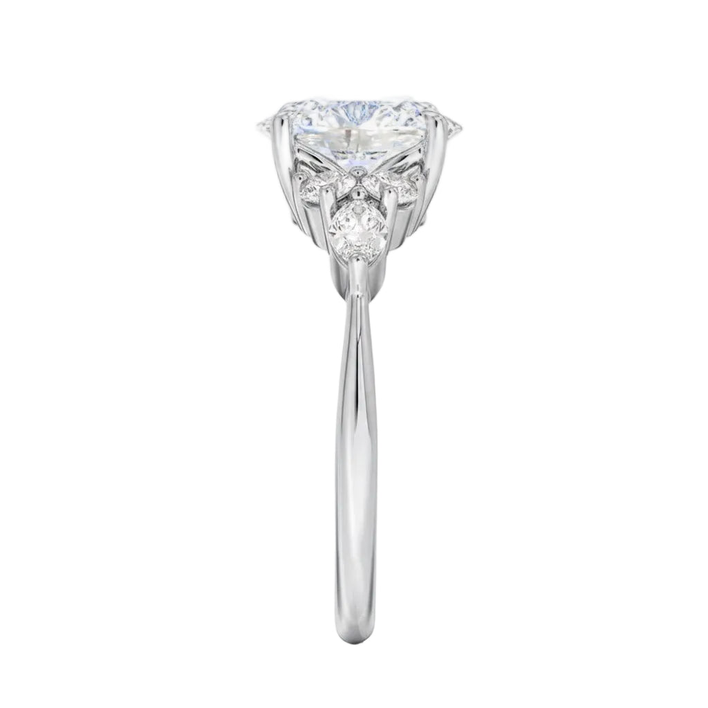 Close-up of a high-quality D-color VVS1 oval moissanite center stone with brilliant round and marquise accents guaranteed by GRI.