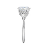 Close-up of a high-quality D-color VVS1 oval moissanite center stone with brilliant round and marquise accents guaranteed by GRI.