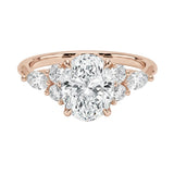 Luxury oval cut moissanite engagement ring in rose gold featuring an organic cluster of round and marquise side stones ApolloGem South Africa.