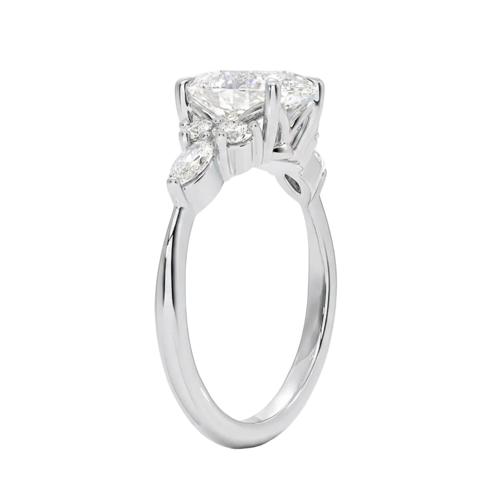 Unique bridal jewelry stack featuring an oval celestial cluster ring paired with a slim gold wedding band for a contemporary look.