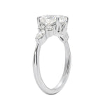 Unique bridal jewelry stack featuring an oval celestial cluster ring paired with a slim gold wedding band for a contemporary look.