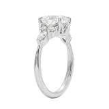 Unique bridal jewelry stack featuring an oval celestial cluster ring paired with a slim gold wedding band for a contemporary look.