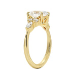Detailed side view of an oval moissanite ring showing the professional prong setting and unique "star-dust" cluster arrangement.